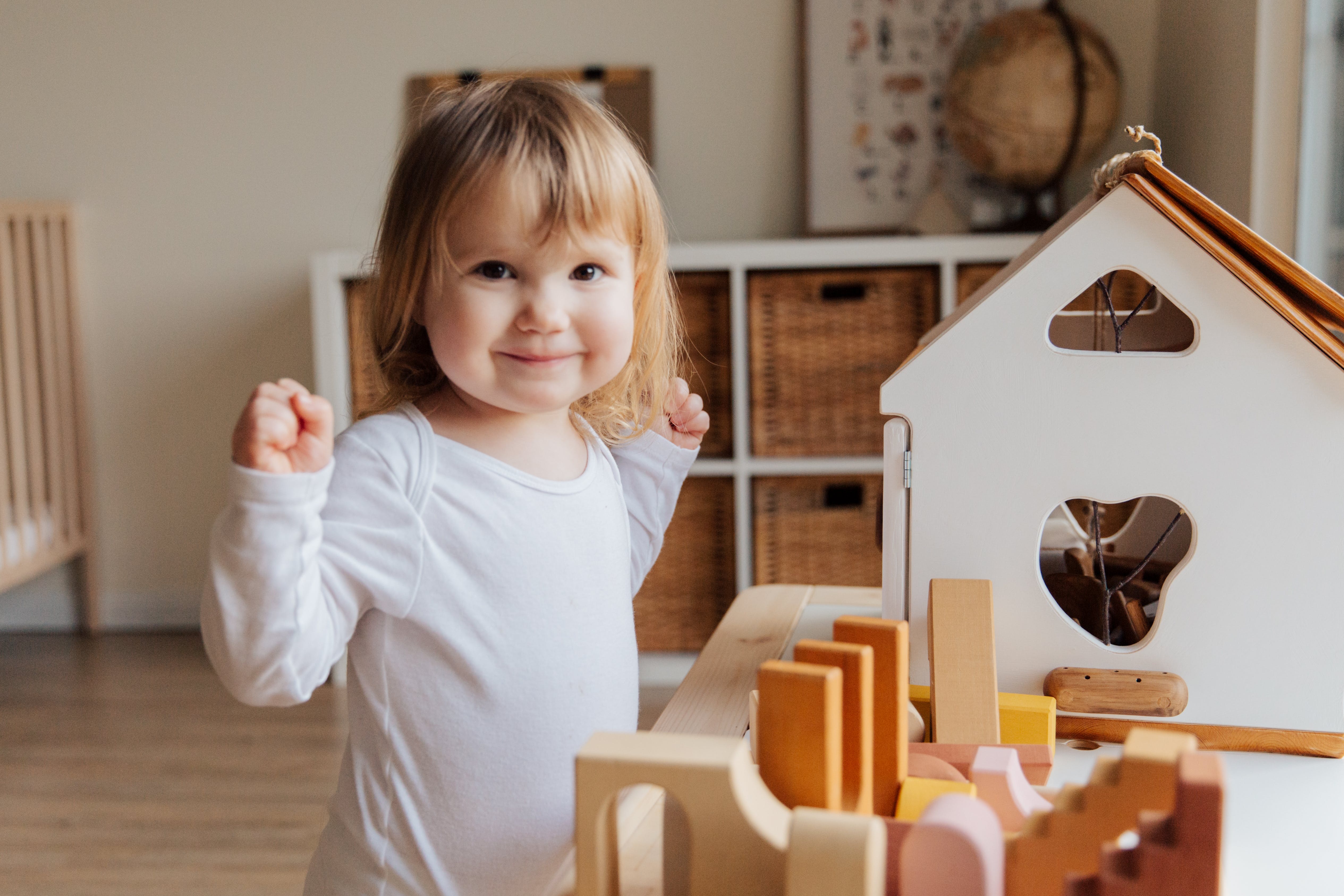 Girl toddler looking happy in nursery/bedroom