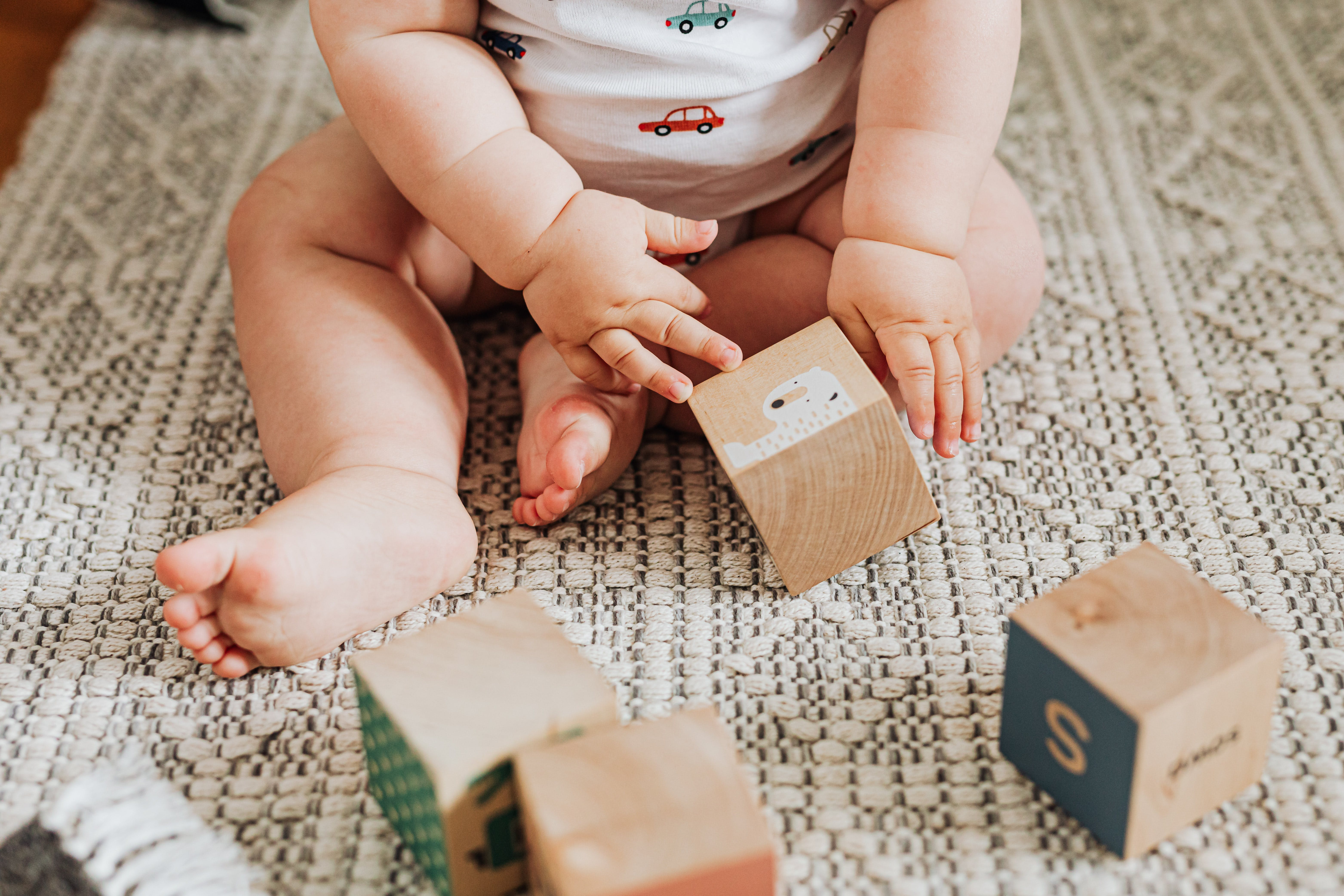 Baby playing with wooden toy blocks