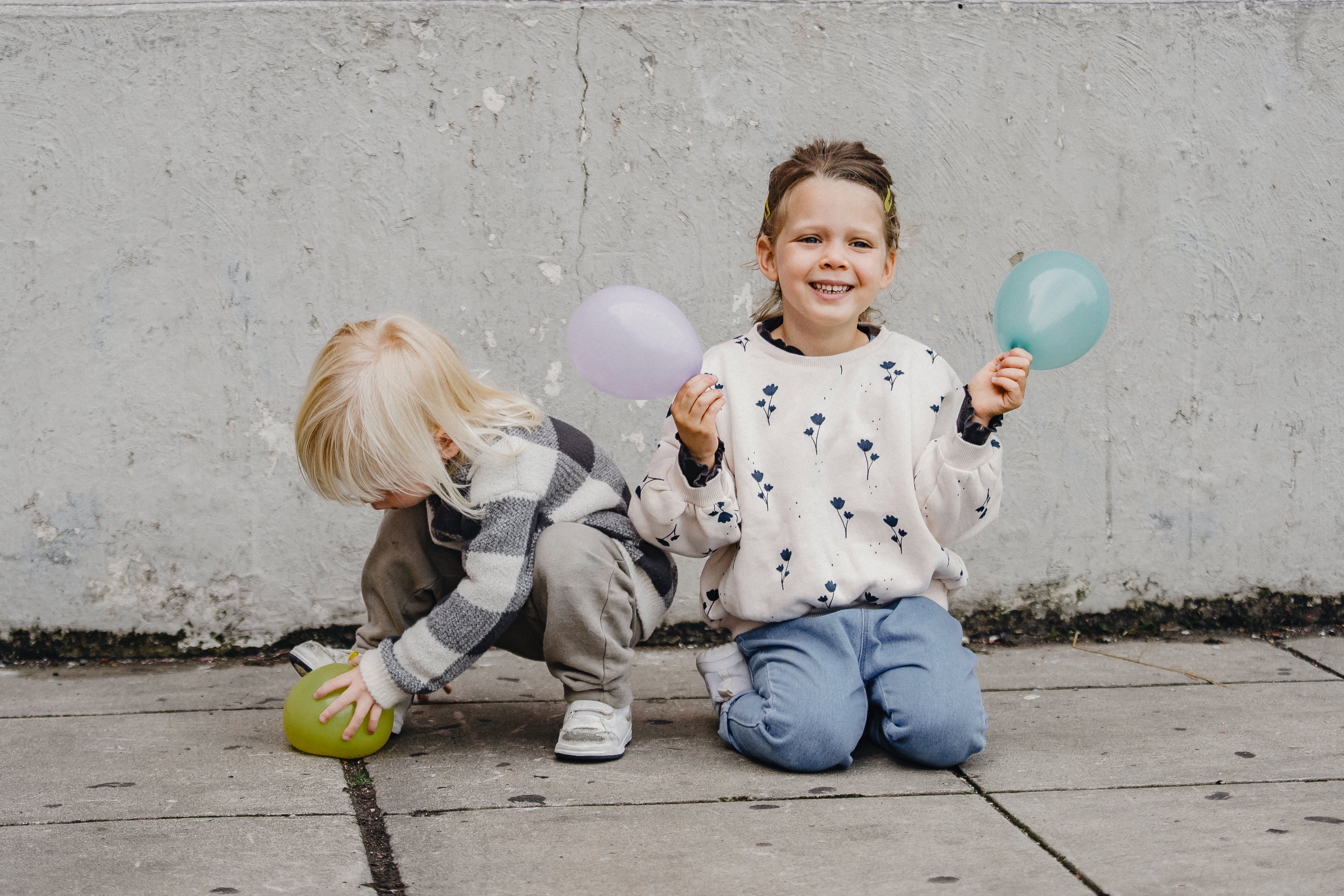 Boy and girl playing with balloons
