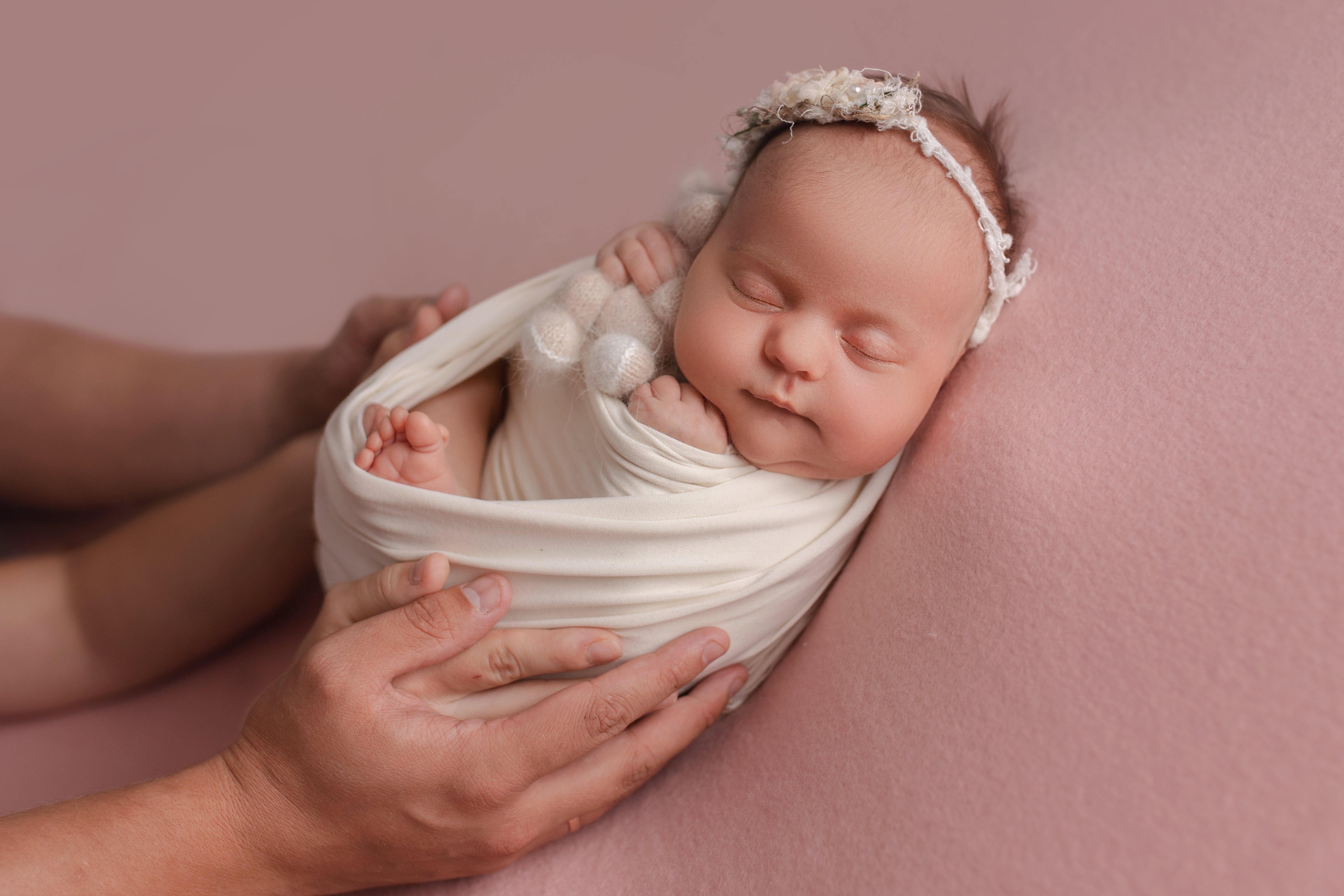 Baby wrapped in muslin swaddle